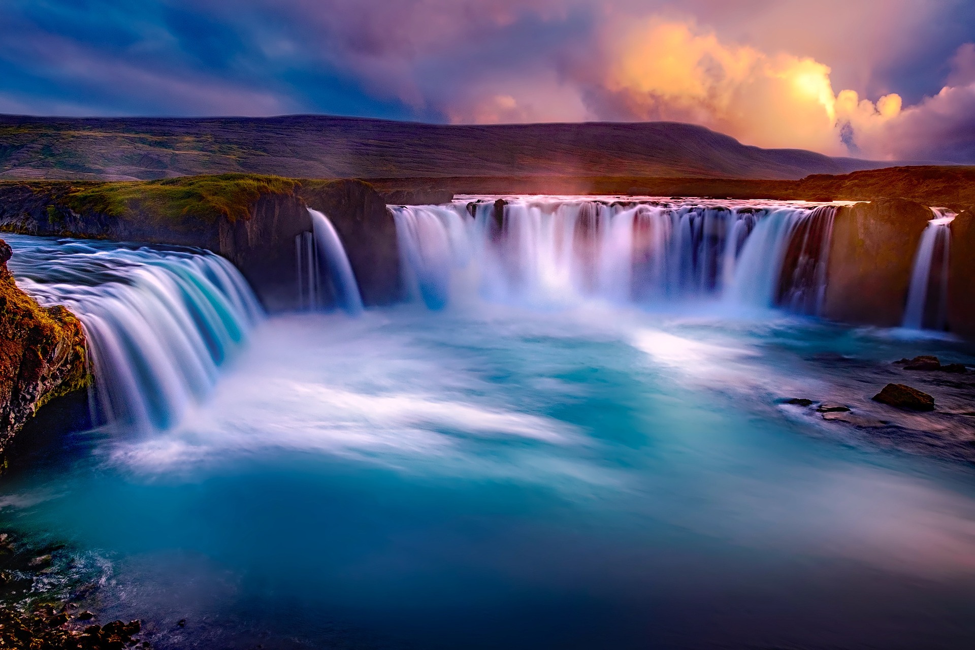 A big waterfall pouring into a large river